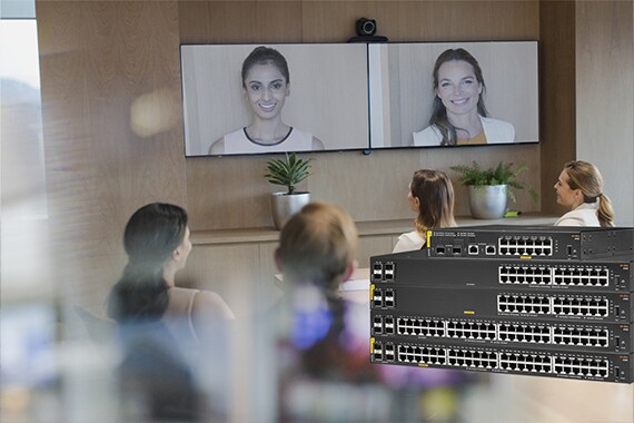 image of a team in an office room looking at a video screen